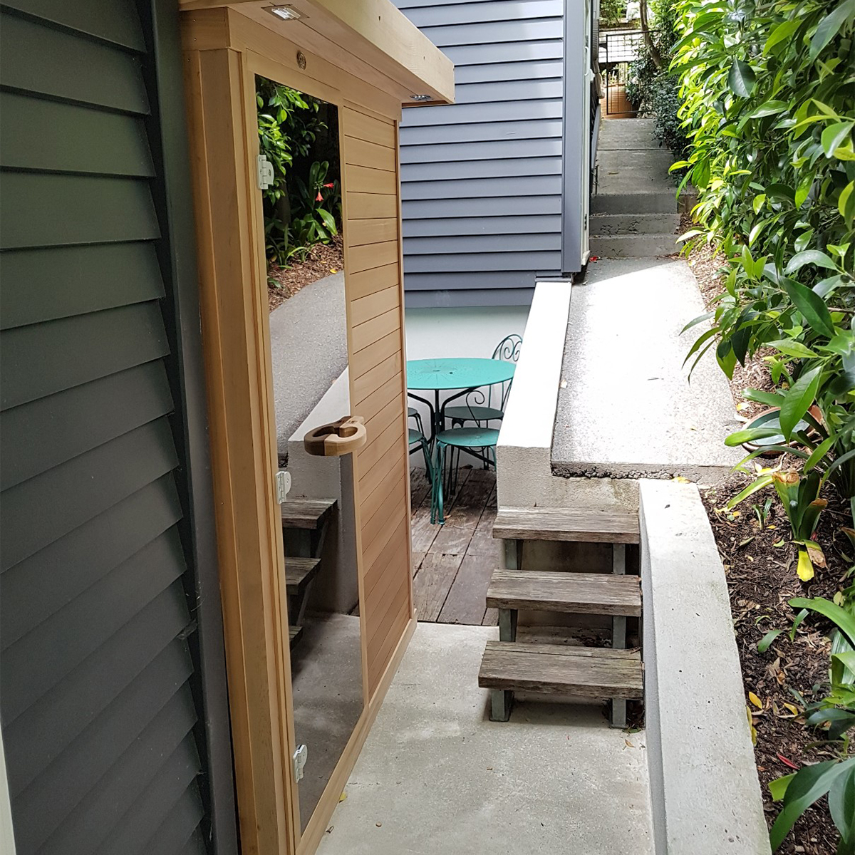 Large 6-person sauna sited on side retreat with glass door